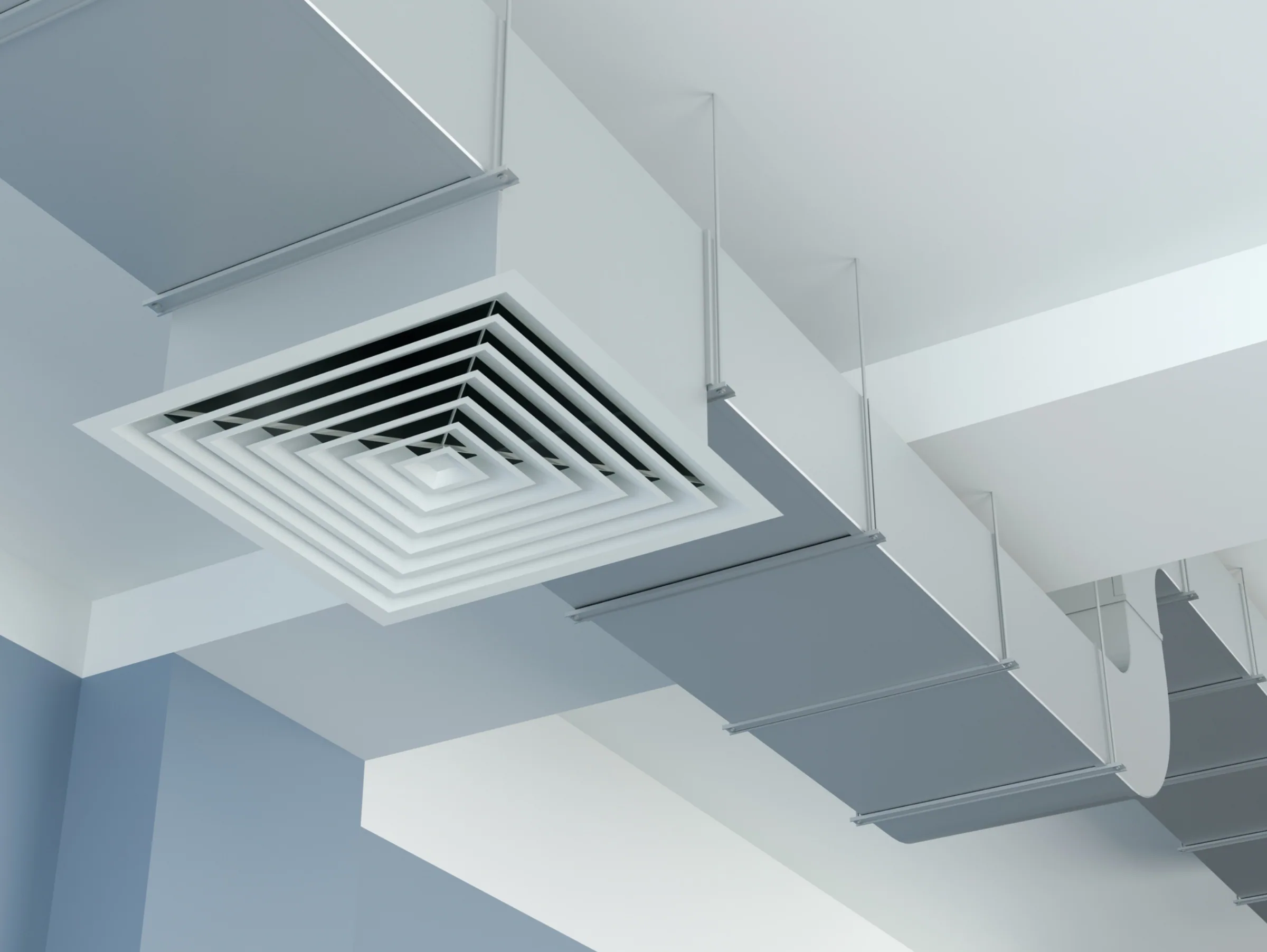 Bouche de diffusion d'air carrée et gaines de ventilation apparentes au plafond d'un bâtiment tertiaire.
